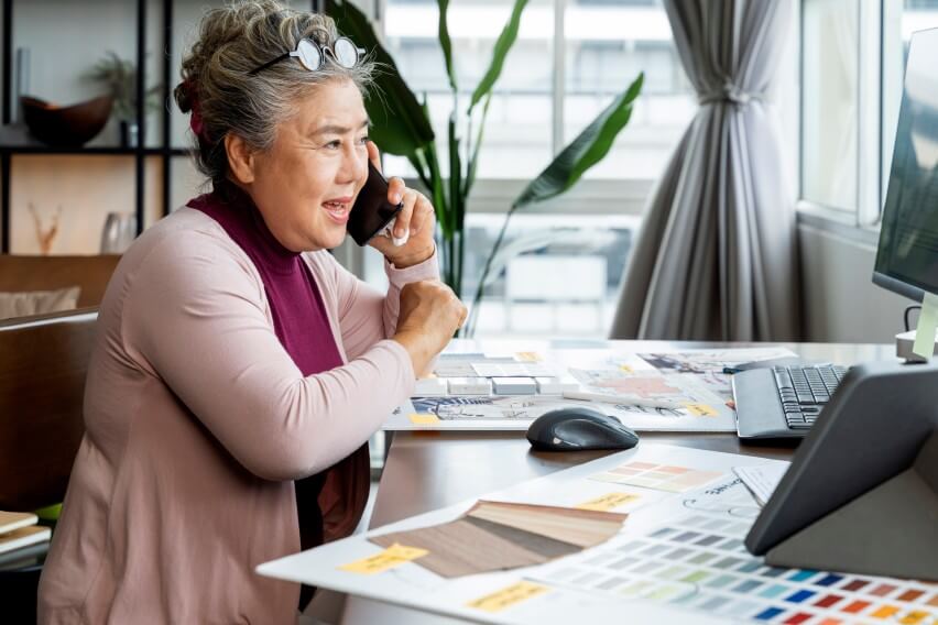 Woman sitting at desk talking on phone